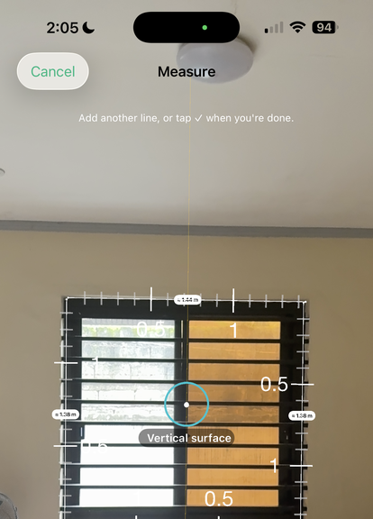 Sayt's measure tool with the camera aimed at a window: a graduated ruler is drawn around the frame with numbered ticks, each side labelled with its own length, and a Vertical surface badge under the crosshair